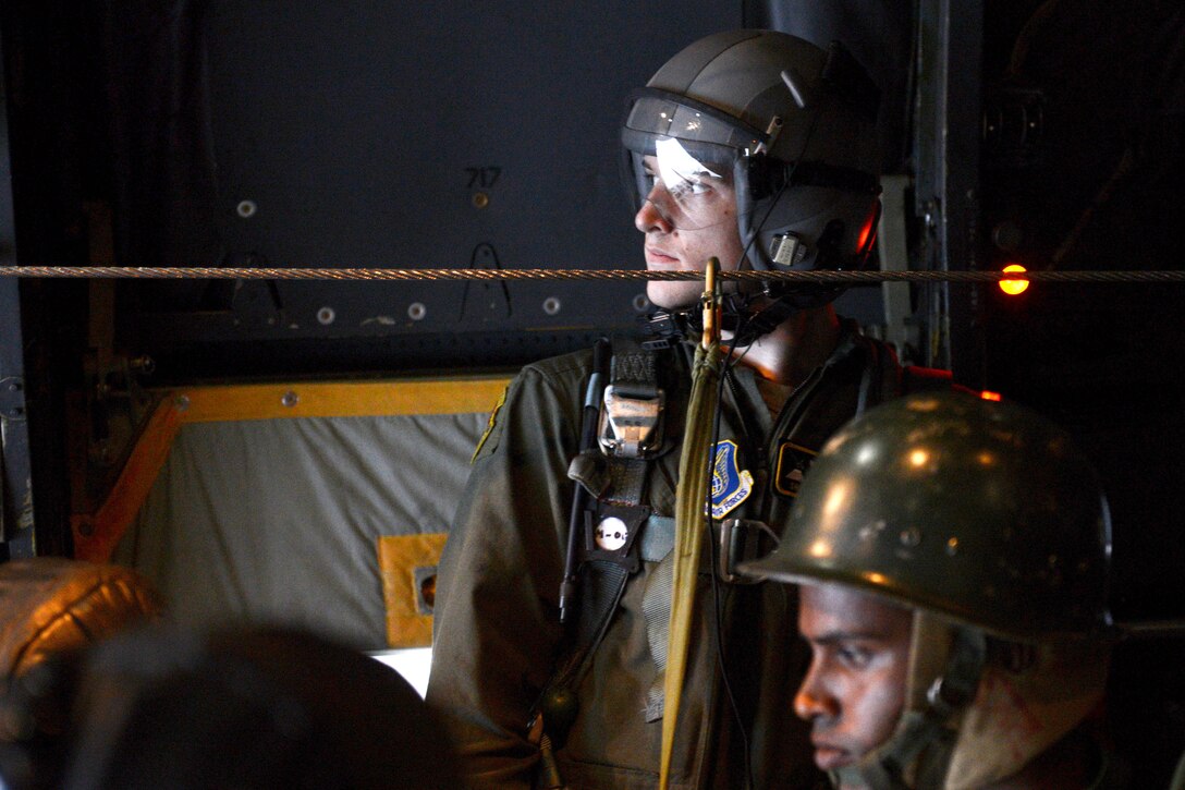 U.S. Air Force Senior Airman Chris Cofer, back, monitors a parachute mission during exercise Cope South near Sylhet, Bangladesh, Jan. 24, 2015. Cofer is a loadmaster assigned to the 36th Airlift Squadron, Yokota Air Base, Japan.