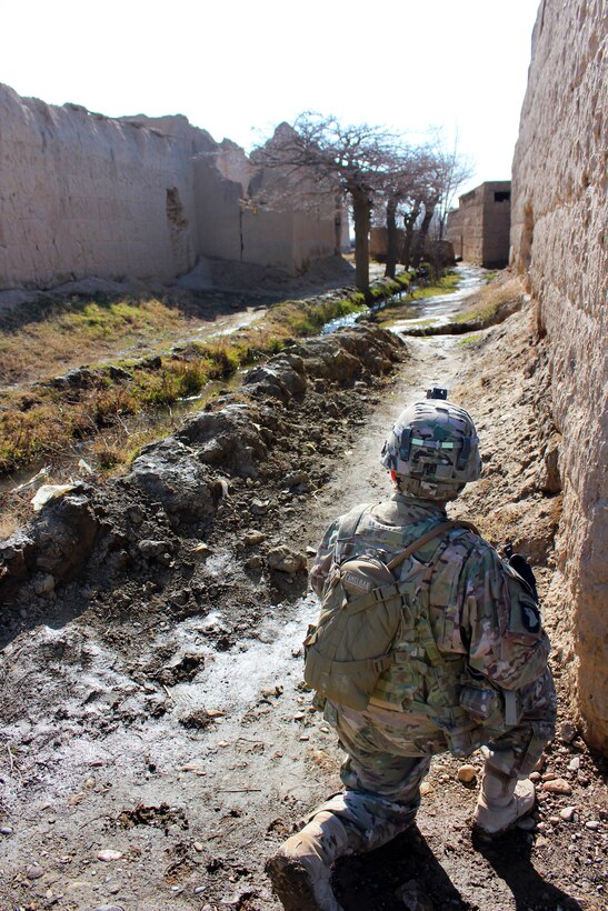 U.S. Army Sgt. Maj. Roland Martinez provides security between buildings during a patrol through a village in Parwan province, Afghanistan, Jan. 27, 2015. Martinez is the senior enlisted advisor assigned to the 3rd Infantry Division's 2nd Squadron, 3rd Cavalry Regiment.