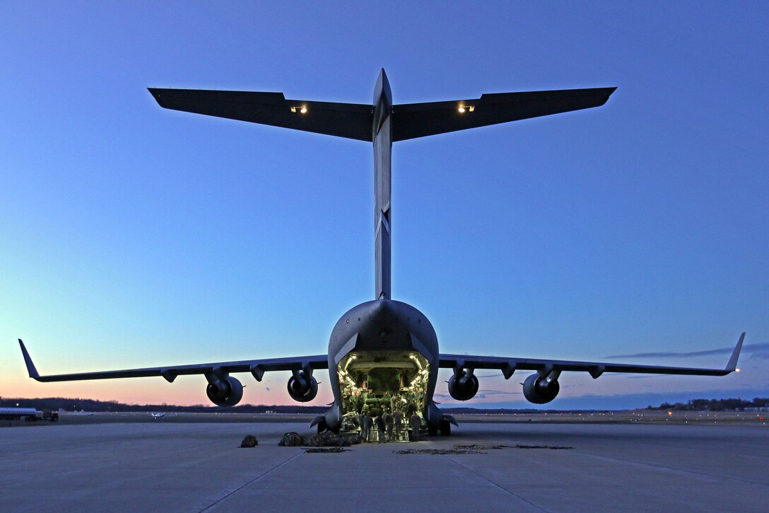 MADISON, Wis. – A 445th Airlift Wing C-17 Globemaster III sits on the tarmac at Traux Field in Madison, Wis., while Soldiers and Airmen work together to load equipment, Jan. 18, 2015. The 89th Airlift Squadron, out of Wright-Patterson Air Force Base, Ohio, provided the 646th Regional Support Group HHC with transportation to their annual training in Virginia. (U.S. Army photo by Sgt. 1st Class Alexander Kartanos)