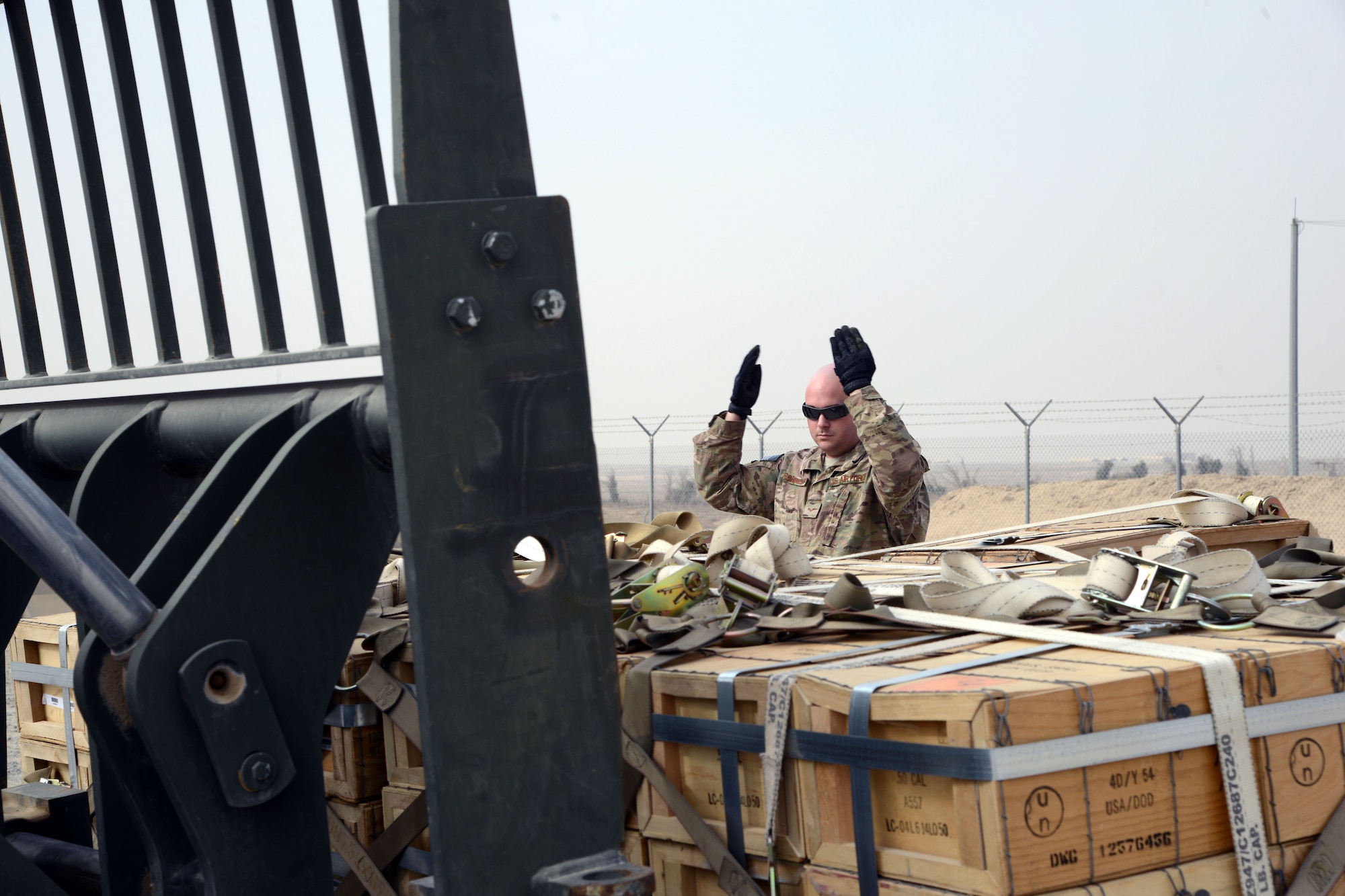 SOUTHWEST ASIA - Senior Airman Douglas Rossmiller, 386th Expeditionary Maintenance Squadron Munitions Flight, directs the movement of a pallet of munitions here Jan. 30, 2015. Since the beginning of Operation INHERENT RESOLVE, the Munitions Flight has adopted three new missions and grown substantially in both storage area and manpower. (U.S. Air Force photo by Tech. Sgt. Jared Marquis/released)