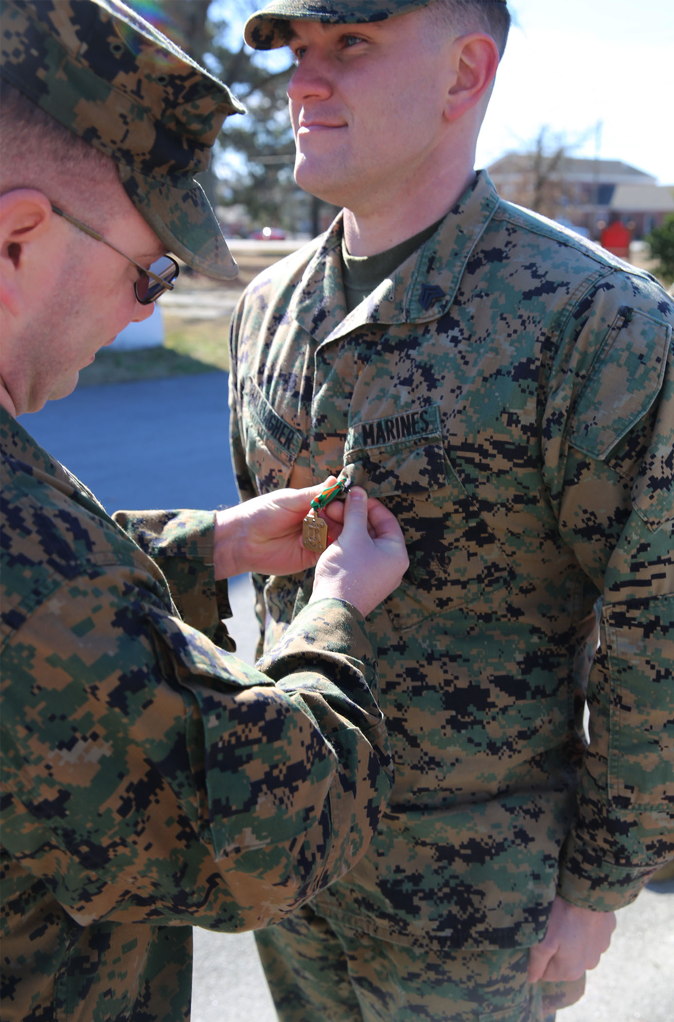 U.S. Marine Corps Sgt. Charles Gallagher, right, 22nd Marine Expeditionary Unit intelligence systems analyst and native of Oscealo, Fla., is awarded the Navy and Marine Corps Achievement Medal at Marine Corps Base Camp Lejeune, N.C., Feb. 3, 2015. (U.S. Marine Corps photo by Cpl. Caleb McDonald/Released)