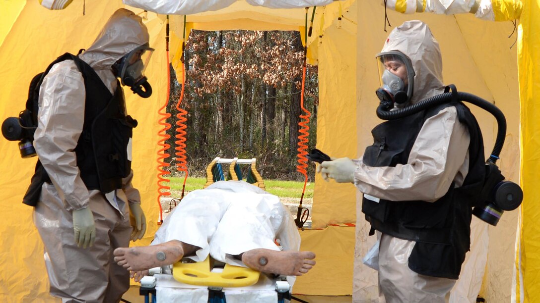 Navy personnel practice treating a victim while wearing protective clothing during training recently at the Naval Branch Health Clinic Albany aboard Marine Corps Logistics Base Albany.The event was held to ensure each area responds correctly in the event of an emergency involving hazardous equipment, people or environments.