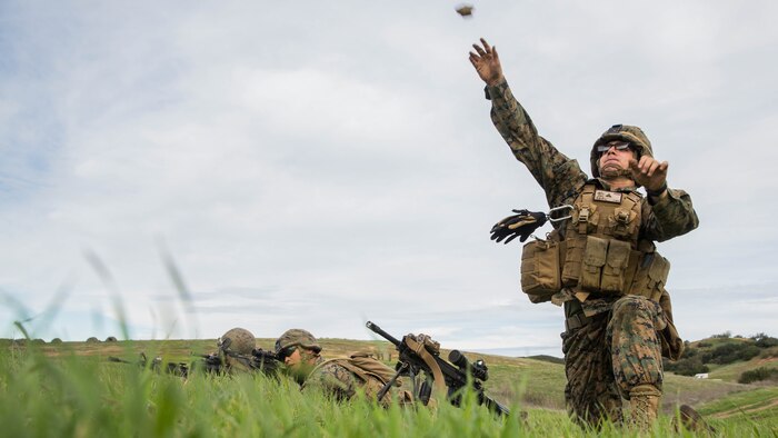 U.S. Marine Pfc. Cody Dunlap throws a simulated grenade during squad tactics and maneuver training aboard Camp Pendleton, Calif., Jan. 26, 2015. Dunlap is an automatic rifleman with Kilo Company, Battalion Landing Team 3rd Battalion, 1st Marine Regiment, 15th Marine Expeditionary Unit. As the ground combat element for the 15th MEU, BLT 3/1 is preparing for their upcoming deployment by enhancing their combat skills and learning to work as a cohesive unit. 