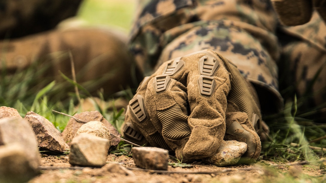 U.S. Marine Lance Cpl. Alexander Dalziel uses rocks to illustrate his plan during squad tactics and maneuver training aboard Camp Pendleton, Calif., Jan. 29, 2015. Dalziel is a team leader with Kilo Company, Battalion Landing Team 3rd Battalion, 1st Marine Regiment, 15th Marine Expeditionary Unit. As the ground combat element for the 15th MEU, BLT 3/1 is preparing for their upcoming deployment by enhancing their combat skills and learning to work as a cohesive unit. 