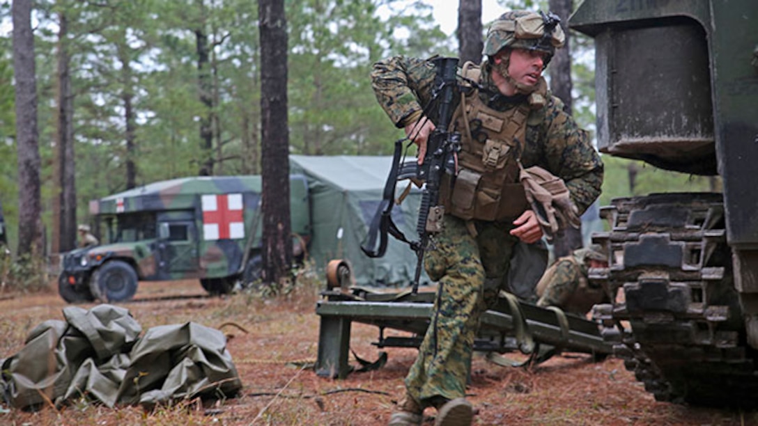 Captain James Smith, an assault amphibious vehicle officer with 2nd Assault Amphibian Battalion, runs for cover during a simulated attack during a week-long field exercise aboard Camp Lejeune, N.C., Jan. 24, 2015. The Battalion faced insurgent role-players during the exercise, which simulated an on-going conflict to maintain combat readiness within the unit.