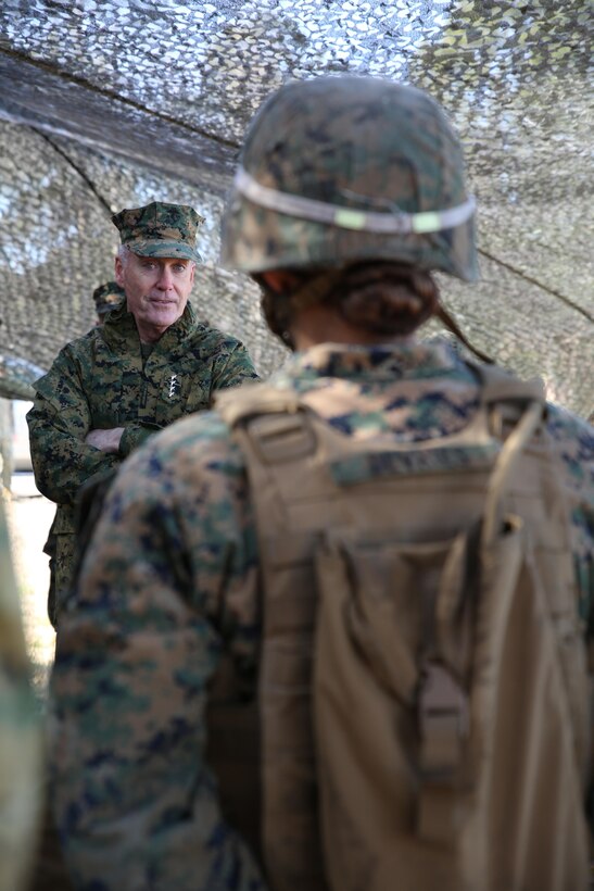Commandant of the Marine Corps Gen. Joseph F. Dunford, Jr., speaks to Cpl. Allison M. Devries, field artillery cannoneer with Battery A, Ground Combat Element Integrated Task Force, about the future of the Corps in between fire missions during their final field exercise at Range GP 13 aboard Marine Corps Base Camp Lejeune, North Carolina, Feb. 3, 2015. Dunford visited GCEITF Marines to observe their training and discuss topics pertaining to the Corps, and how the Marines are helping shape a better Marine Corps. From October 2014 to July 2015, the GCEITF will conduct individual and collective level skills training in designated ground combat arms occupational specialties in order to facilitate the standards based assessment of the physical performance of Marines in a simulated operating environment performing specific ground combat arms tasks. (U.S. Marine Corps photo by Sgt. Alicia R. Leaders/Released)