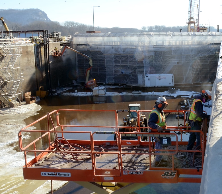 Kris Taverna, left, and Dale Rud, both of operations, work to remove damaged concrete from the lockwall at Lock and Dam 5A on January 15, 2015. Lock 5A was closed to navigation on Dec. 1, 2014, in order to complete the necessary work by March 9, 2015.