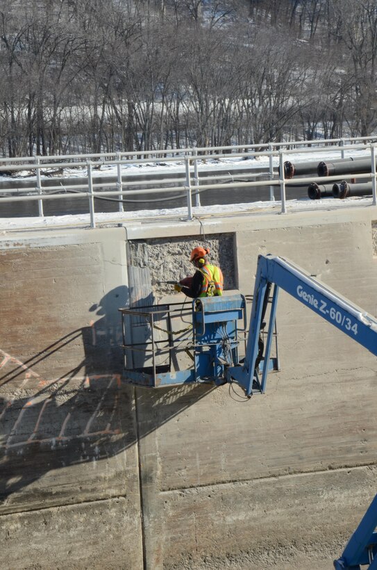 Jordon Johnson, operations, operates a jackhammer to remove damaged concrete on Lock and Dam 5A's lock chamber walls on January 15, 2015. Lock 5A was closed to navigation on Dec. 1, 2014, in order to complete the necessary work by March 9, 2015.