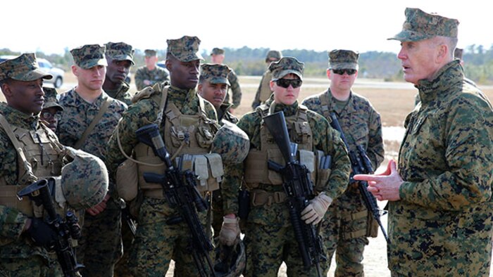 Commandant of the Marine Corps Gen. Joseph F. Dunford, Jr., speaks to Marines of Company A and Weapons Company during their final field exercise at Range G6 aboard Marine Corps Base Camp Lejeune, N.C., Feb. 3, 2015. Dunford visited GCEITF Marines to observe their training and discuss the future of the Corps, and how the Marines are helping shape a better Marine Corps. From October 2014 to July 2015, the GCEITF will conduct individual and collective level skills training in designated ground combat arms occupational specialties in order to facilitate the standards based assessment of the physical performance of Marines in a simulated operating environment performing specific ground combat arms tasks. (U.S. Marine Corps photo by Sgt. Alicia R. Leaders/Released)
