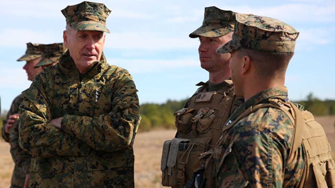 Commandant of the Marine Corps Gen. Joseph F. Dunford, Jr., left, speaks with Captains Raymond P. Kaster, center, company commander of Company A, and Mark A. Lenzi, company commander of Weapons Company, during his observation of the companies’ final field exercise at Range G6 aboard Marine Corps Base Camp Lejeune, N.C., Feb. 3, 2015. Dunford visited GCEITF Marines to observe their training and discuss topics pertaining to the Corps, and how the Marines are helping shape a better Marine Corps. From October 2014 to July 2015, the GCEITF will conduct individual and collective level skills training in designated ground combat arms occupational specialties in order to facilitate the standards based assessment of the physical performance of Marines in a simulated operating environment performing specific ground combat arms tasks. (U.S. Marine Corps photo by Sgt. Alicia R. Leaders/Released)
