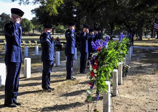 Airmen salute the graves of Spirit 03 crew members during a remembrance ceremony at Barrancas National Cemetery on Naval Air Station Pensacola, Fla., Jan. 31, 2015. During the Battle of Khafji, Spirit 03, an AC-130H Spectre, was shot down in the early hours of Jan. 31, 1991. (U.S. Air Force photo/Airman 1st Class Jeff Parkinson)