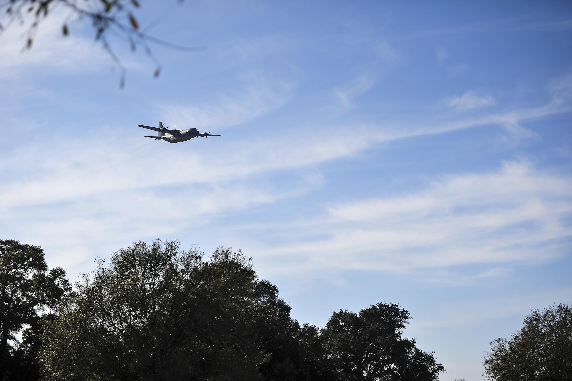 A soon-to-be retired AC-130H Spectre makes a final flyover during a remembrance ceremony at Barrancas National Cemetery on Naval Air Station Pensacola, Fla., Jan. 31, 2015. The AC-130H Spectre’s primary missions are close air support, air interdiction and armed reconnaissance. (U.S. Air Force photo/Airman 1st Class Jeff Parkinson)