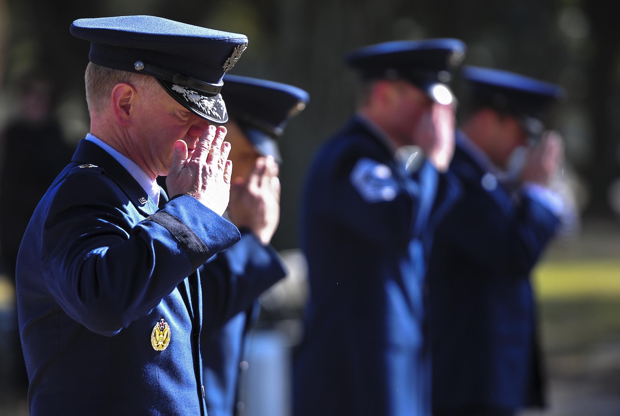 Maj. Gen. Mark Hicks, Air Force Special Operations Command director of operations, salutes the graves of Spirit 03 crew members during a remembrance ceremony at Barrancas National Cemetery on Naval Air Station Pensacola, Fla., Jan. 31, 2015. Losing Spirit 03 and its crew members was the largest single loss by an Air Force unit during Operation Desert Storm. (U.S. Air Force photo/Airman 1st Class Jeff Parkinson)