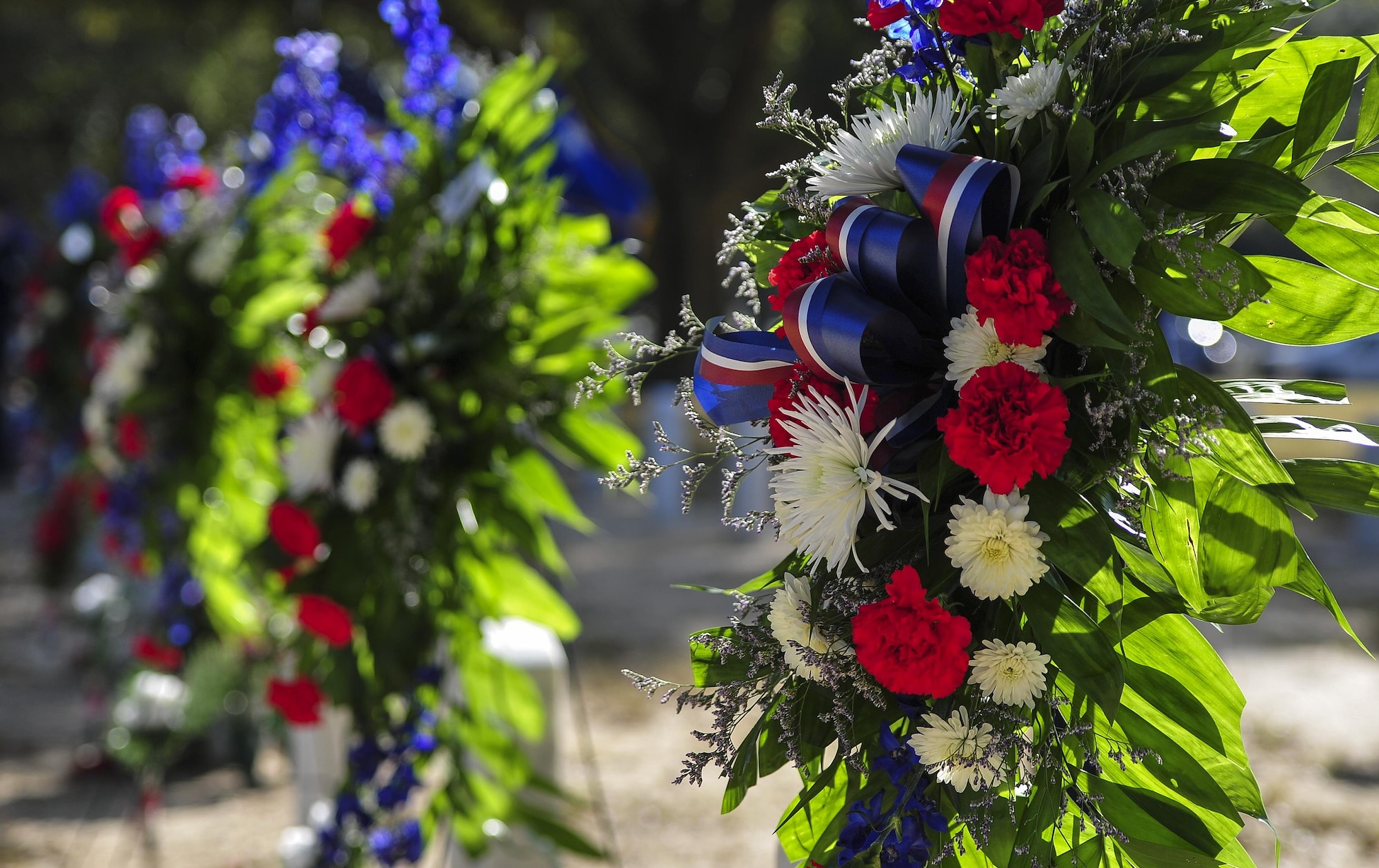 Wreaths are displayed on the graves of Spirit 03 crew members during a remembrance ceremony at Barrancas National Cemetery on Naval Air Station Pensacola, Fla., Jan. 31, 2015. While providing support for joint forces on Jan. 31, 1991, Spirit 03 was shot down, and 14 crew members lost their lives. (U.S. Air Force photo/Airman 1st Class Jeff Parkinson)