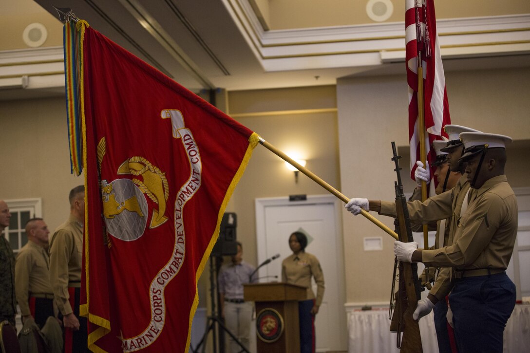 A Marine Corps color guard retires the colors during the Commandant of the Marine Corps 2014 Combined Awards Ceremony at the Clubs at Quantico in Quantico, Va., Jan. 29, 2015. The ceremony recognized superior recruiters, drill instructors, combat Instructors, Marine security guards, career planners and Semper Fit male and female Athletes of the Year. (U.S. Marine Corps photo by Cpl. Gabrielle Quire/Released)