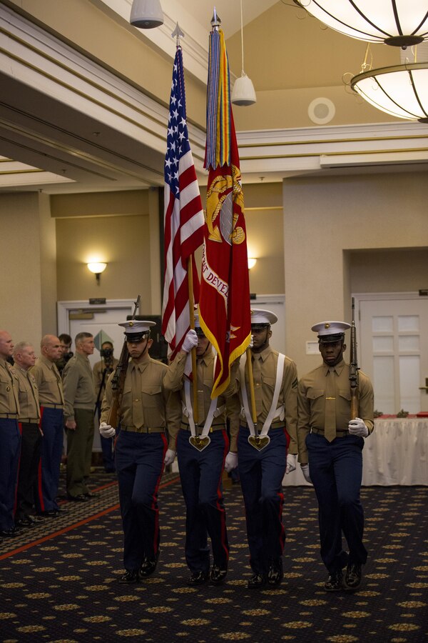 A Marine Corps color guard retires the colors during the Commandant of the Marine Corps 2014 Combined Awards Ceremony at the Clubs at Quantico in Quantico, Va., Jan. 29, 2015. The ceremony recognized superior recruiters, drill instructors, combat Instructors, Marine security guards, career planners and Semper Fit male and female Athletes of the Year. 