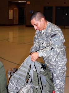 Spc. Ronnie Garza repacks one of his duffel bags at the Fargo Armed Forces Reserve Center on May 18, 2010. Garza, who serves with the North Dakota Army National Guard’s 191st Military Police Company, volunteered to take part on a three-week humanitarian mission in Haiti. The Soldiers left Fargo on May 19.