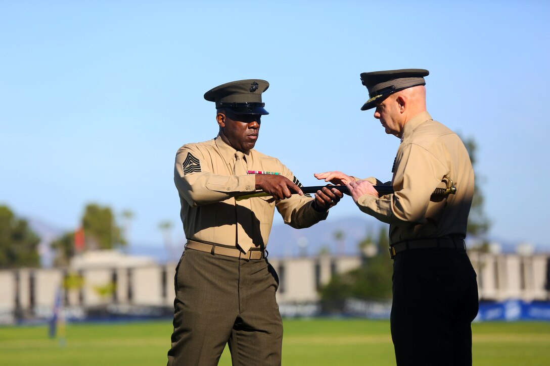 Sergeant Maj. Ronald Green returns the noncommissioned officer’s sword to Lt. Gen. David H. Berger, I Marine Expeditionary Force commanding general, signifying the end of his tour as the I MEF sergeant major, during a relief and appointment ceremony aboard Marine Corps Base Camp Pendleton, Calif., Feb. 4, 2015. During the ceremony, the Marines bid farewell to Green as he prepares to assume his new post as the Sergeant Major of the Marine Corps, and welcomed Sgt. Maj. Bradley Kasal as the new I MEF sergeant major. (U.S. Marine Corps photo by Cpl. Christopher J. Moore/Released)
