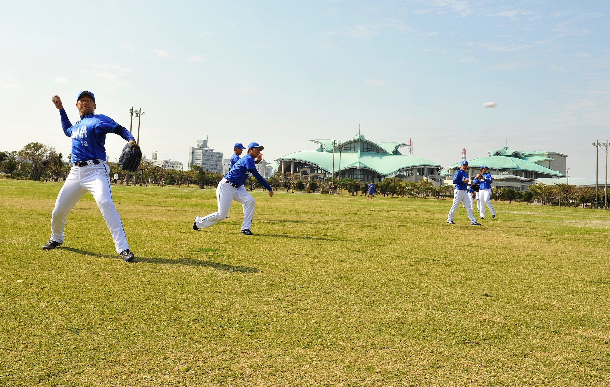 Pitchers from the Yokohama DeNA Baystars practice long throws during a spring training camp at the Ginowan Municipal Baseball Stadium, Okinawa, Japan, Feb. 2, 2015. The camp is held on Okinawa due to the island's mild climate, the many professional baseball teams in the area that are available for practice games, and the abundance of sports facilities. (U.S. Air Force photo by Naoto Anazawa)
