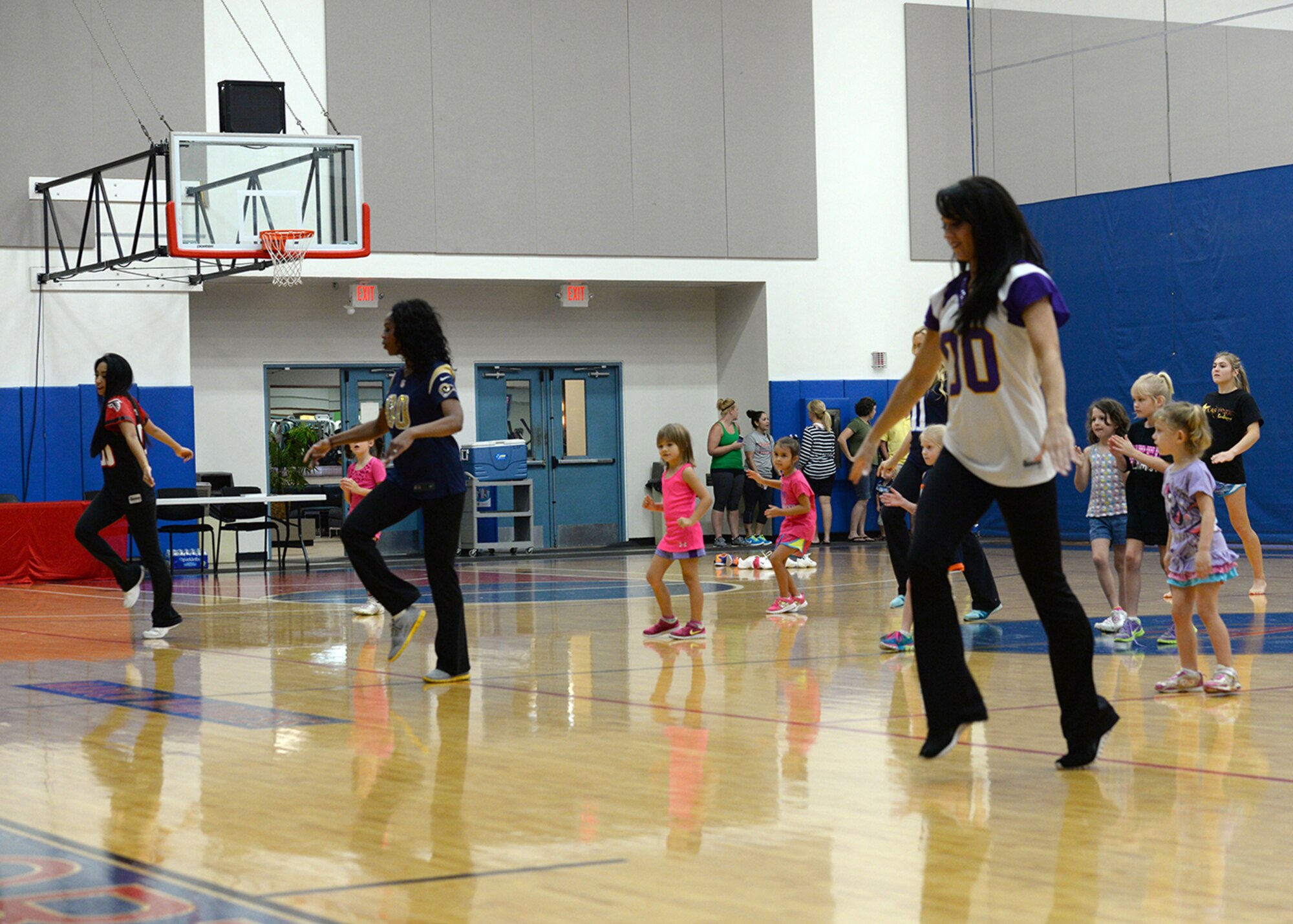 National Football League cheerleaders from the Atlanta Falcons, St. Louis Rams and Minnesota Vikings lead children through a cheer clinic Feb. 1, 2015, at the Coral Reef Fitness Center at Andersen Air Force Base, Guam. The cheerleaders visited Andersen as part of the Department of Defense’s Armed Forces Entertainment Guam Super Bowl tour that brought the cheerleaders, NFL mascots and two former NFL players to the island for two days to meet military members and watch the Super Bowl Feb. 3 at Andersen and Naval Base Guam. (U.S. Air Force photo by Tech. Sgt. Zachary Wilson/Released)