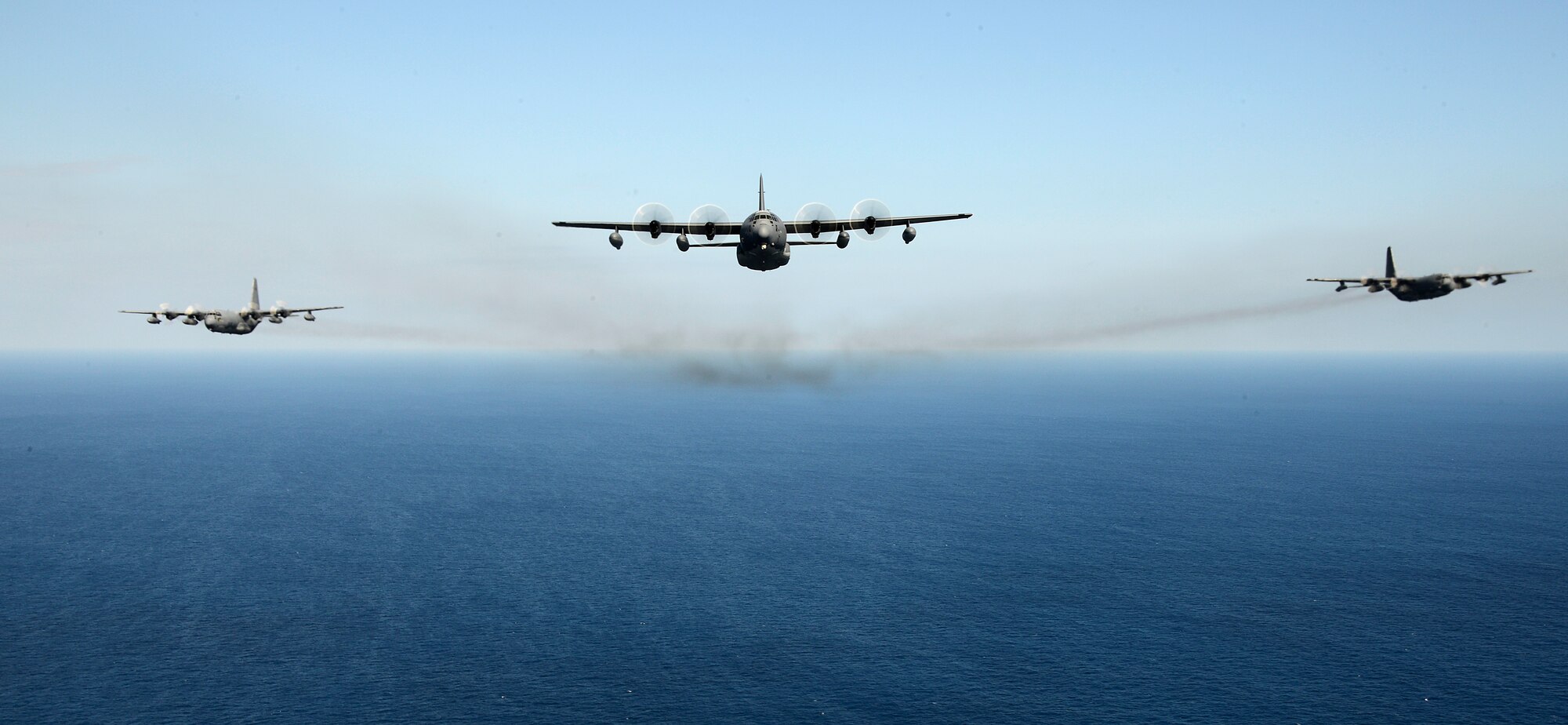 The MC-130J Commando II leads the heritage formation of three MC-130 variants off the coast of Okinawa, Japan, Jan. 26, 2015. The 353rd Special Operations Group performed the unique formation to commemorate the arrival of the MC-130J Commando II, the retirement of the MC-130P Combat Shadow and the continuing mission of the MC-130H Combat Talon II. (U.S. Air Force photo by Senior Airman Maeson Elleman)