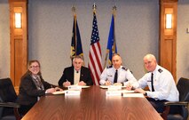 From left, Jane Weber, Cascade County commissioner; The Honorable Michael Winters, Great Falls, Mont., Mayor; Col. Tom Wilcox, 341st Missile Wing commander, and Col. Pete Hronek, 120th Airlift Wing commander, sign the Malmstrom Community Partnership Executive Leader Council charter. The charter, part of the Air Force Community Partnership Initiative, aims to bridge the gap between Malmstrom Air Force Base and the local community to build partnerships and collaborate in order to maximize shared benefits between the two parties. (U.S. Air Force photo/Airman 1st Class Dillon Johnston)