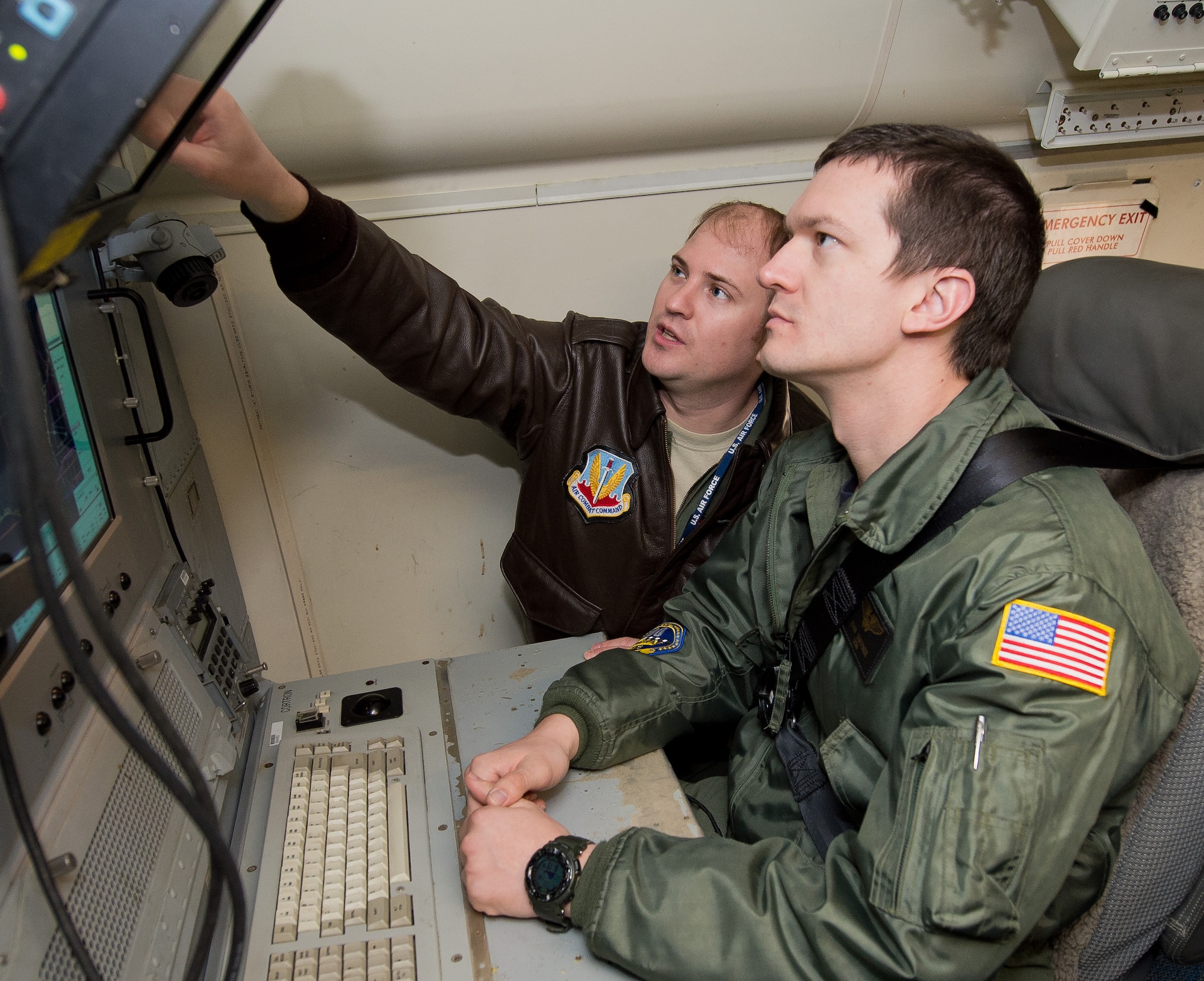 U.S. Navy Lt. j.g. John Duffner, right, a naval flight officer with Carrier Airborne Early Warning Squadron 126, receives pre-flight instructions from a U.S. Air Force aircrew member with the 461st Air Control Wing prior to a mission aboard an E-8C Joint STARS, Robins Air Force Base, Ga., Jan. 30, 2015. Duffner, from Naval Station Norfolk, flew two missions with Team JSTARS as a liaison officer to learn more about the capabilities of the Joint STARS weapon system and share his experience with his carrier group. During the Composite Training Unit Exercise, JSTARS used their unique Command and Control, Intelligence, Surveillance, Reconnaissance and Battle Management capabilities to provide the warfare commander long-range, air-to-surface wide area surveillance to track ground and maritime targets in all weather conditions. Aircrew members from the 116th Air Control Wing, Georgia Air National Guard, Team JSTARS host unit, also flew on board the 30-person crew. (U.S. Air National Guard photo by Master Sgt. Roger Parsons/Released) (JSTARS crewmember name withheld for security purposes)