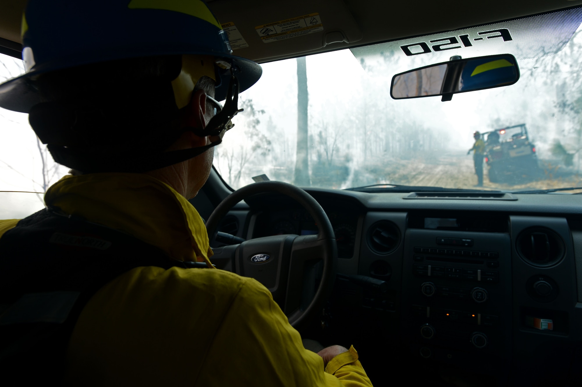 Ronald June, 20th Civil Engineer Squadron chief of natural and cultural resources, observes U.S. Fish and Wildlife Service employees conduct a prescribed burn at the Poinsett Electronic Combat Range, Sumter, S.C., Jan. 28, 2015. Due to certification requirements, the 20th CES partners with several government organizations to accomplish the wildlife and resource mission at the range. (U.S. Air Force photo by Senior Airman Jensen Stidham/Released) 
