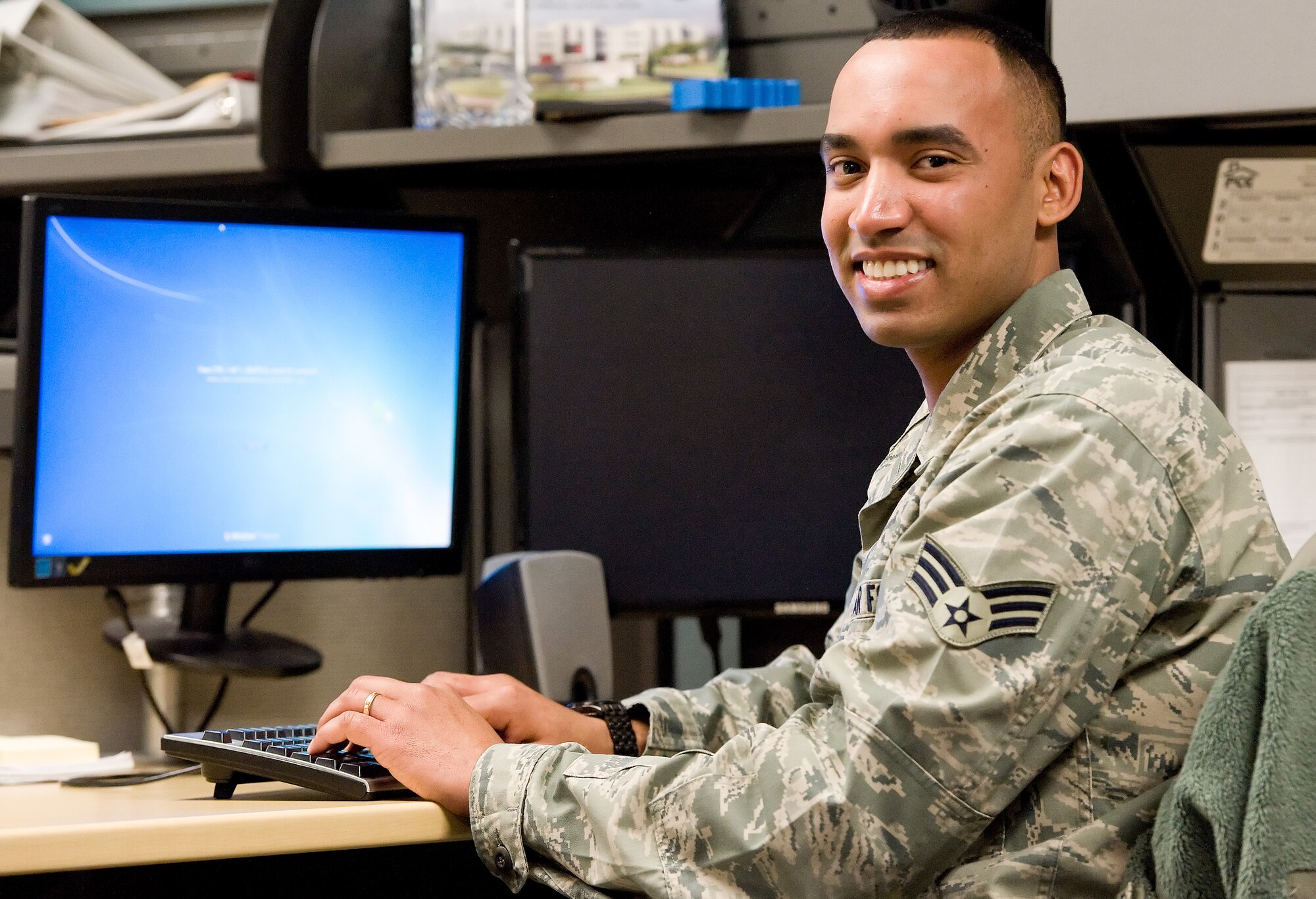 Senior Airman Cesar Pimental, 436th Medical Support Squadron unit deployment manager, gets ready to start his day Jan. 30, 2015, at the base clinic on Dover Air Force Base, Del. Pimental was named the Air Mobility Command 2014 Outstanding Health Services Management Airman of the Year. (U.S. Air Force photo/Roland Balik)

