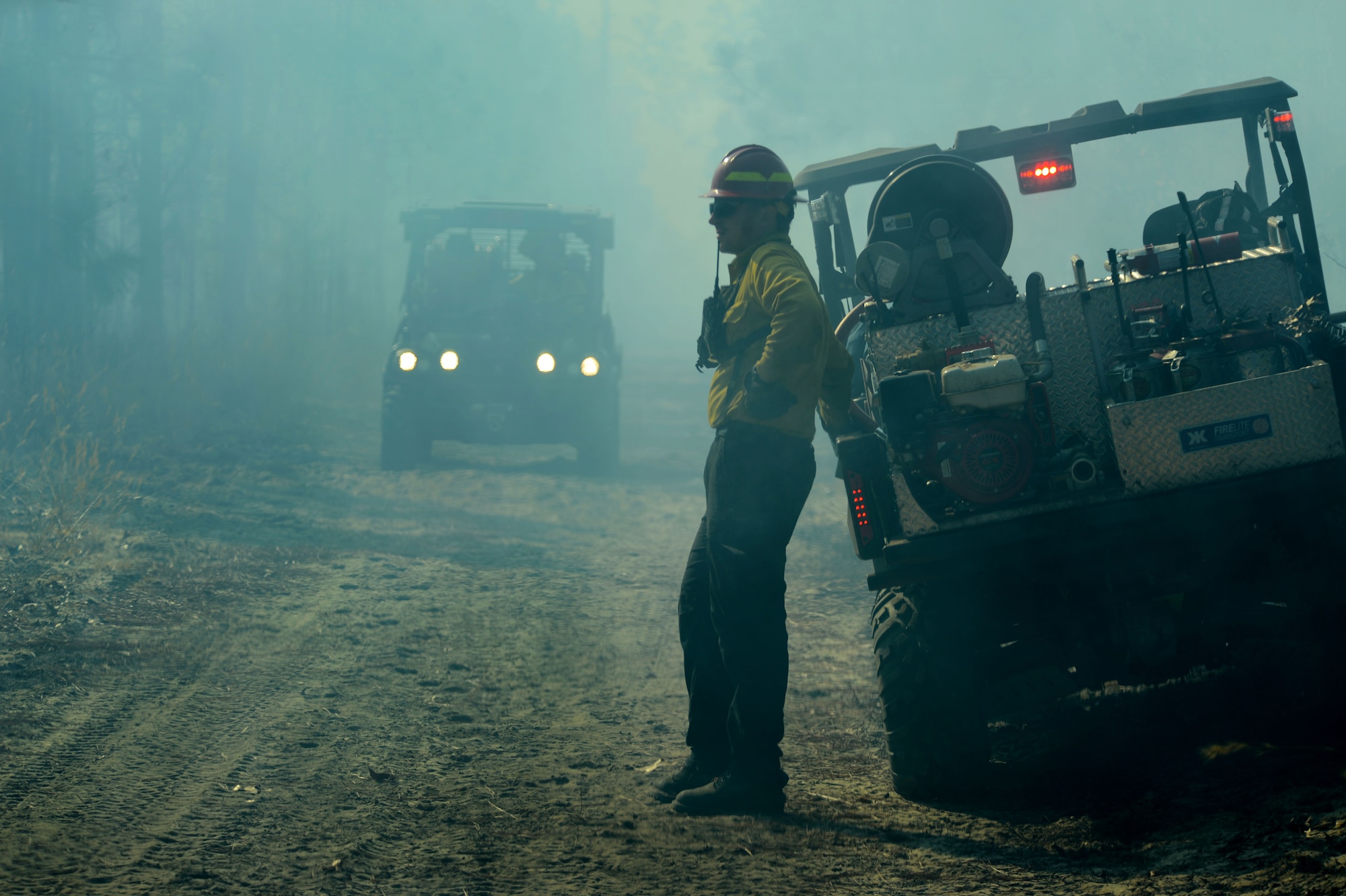 A U.S. Fish and Wildlife Service fire module detail member monitors a prescribed burned at the Poinsett Electronic Combat Range, Sumter, S.C., Jan. 28, 2015.  Prescribed burns are purposely set fires, burning off layers of dried brush on the forest floor to maintain a healthy environment for plants and animals. (U.S. Air Force photo by Senior Airman Jensen Stidham/Released) 