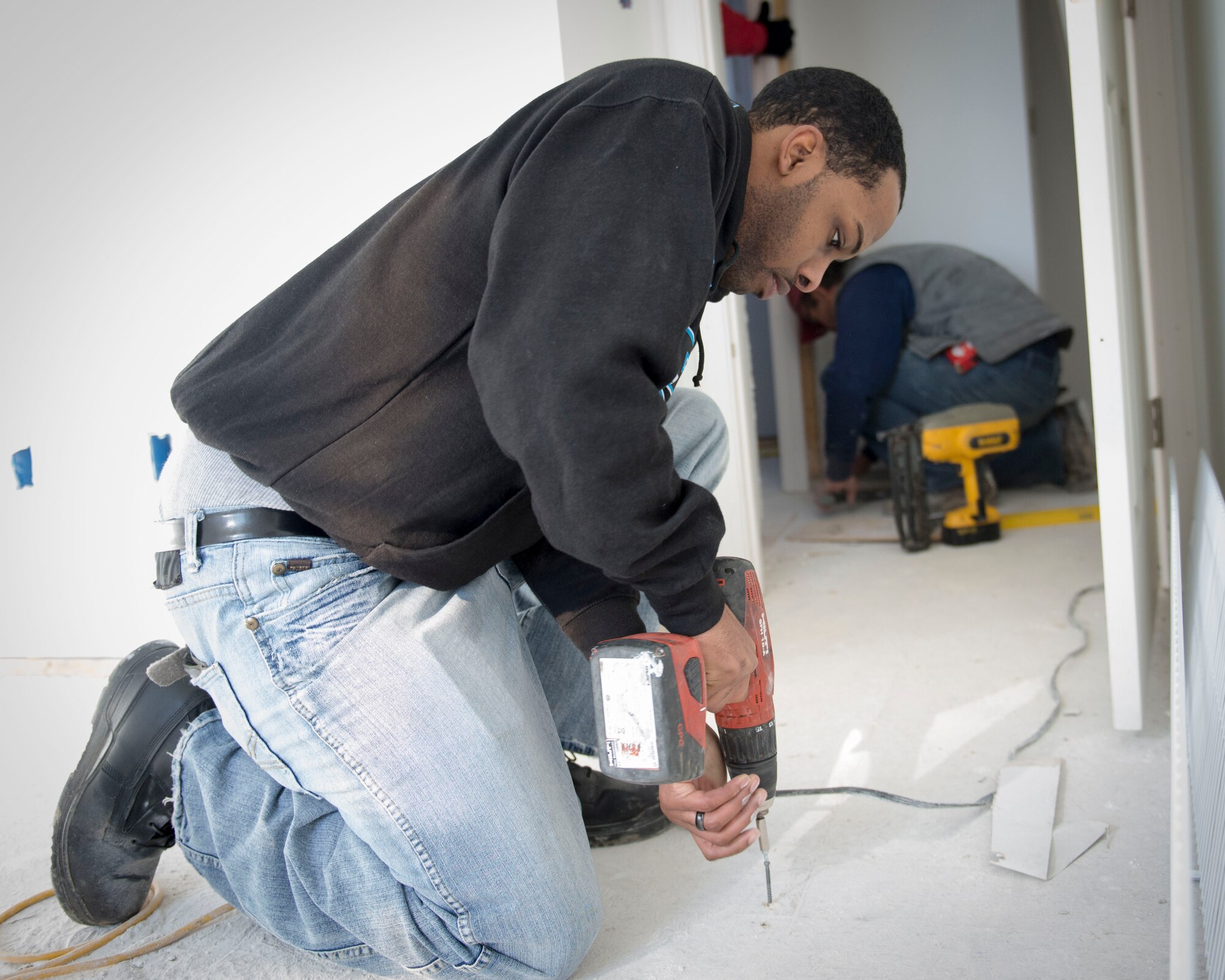 Staff Sgt. Mario Super, Air Force Mortuary Affairs Operations Honor Guard Policy program manager, secures a floor board while volunteering with Habitat for Humanity in Frederica, Del., Jan. 31, 2015. AFMAO Airmen regularly conduct volunteer projects in the local community. (U.S. Air Force photo/Capt. Raymond Geoffroy) 
