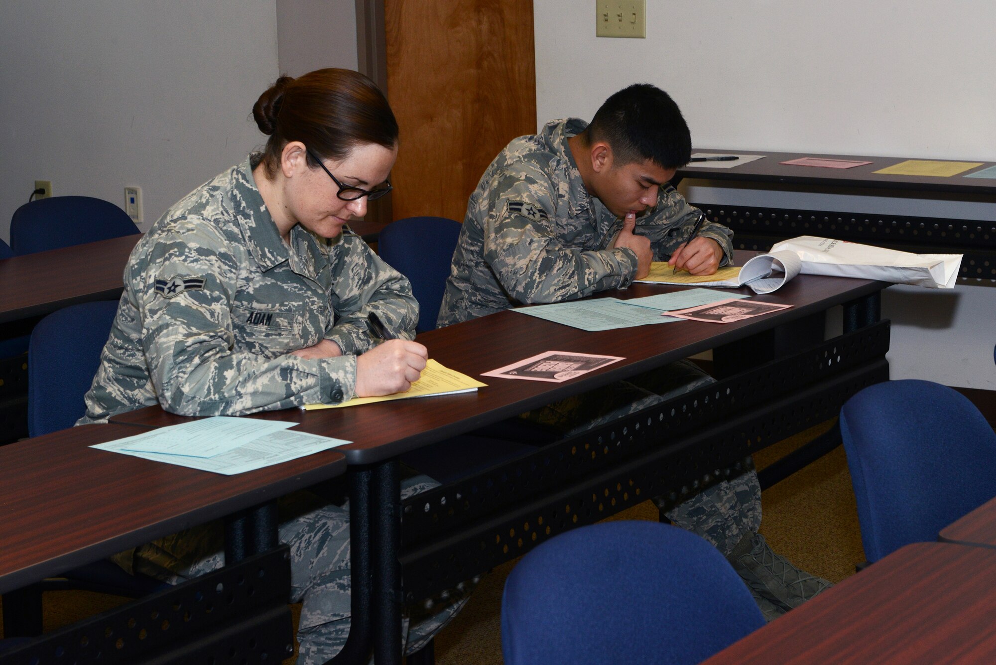 U.S. Air Force Airman 1st Class Reniro Viguilla, right, and Airman 1st Class Jennalyse Adam, 23d Aerospace Medicine Squadron dental assistants, fill out forms during a financial class Feb. 2, 2015, at Moody Air Force Base, Ga. The class covered budgeting and aligning financial goals with personal values. (U.S. Air Force photo by Airman 1st Class Kathleen D. Bryant)