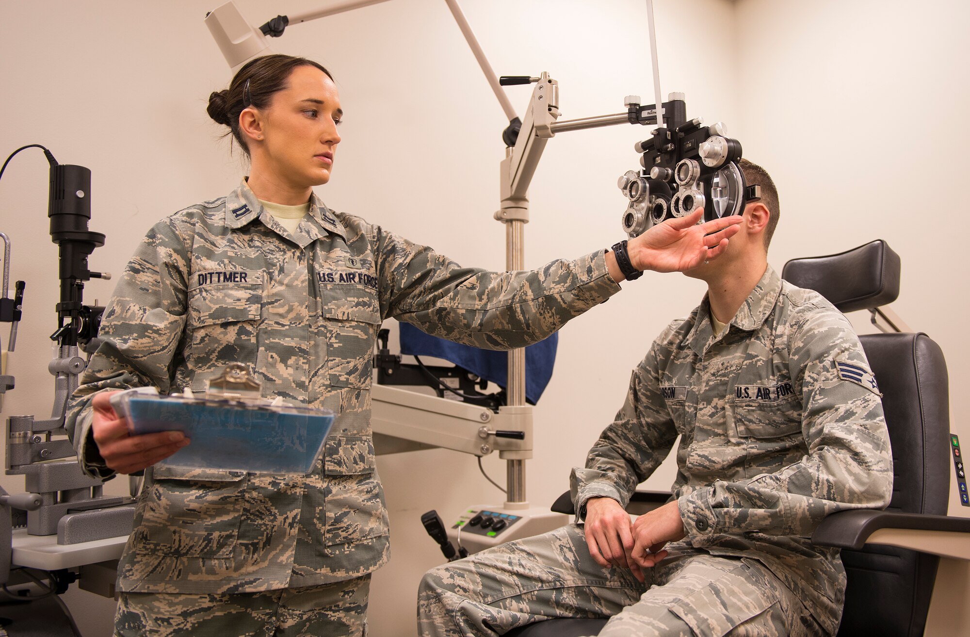 U.S. Air Force Capt. (Dr.) Kaylaen Dittmer, 23d Medical Group optometrist, adjusts the phoropter for Senior Airman River Carson, 23d MDG public health technician Feb. 4, 2014, at Moody Air Force Base, Ga.  Phoropters contain different lenses to help identify prescription needs. (U.S. Air Force photo by Airman 1st Class Ceaira Tinsley/Released)