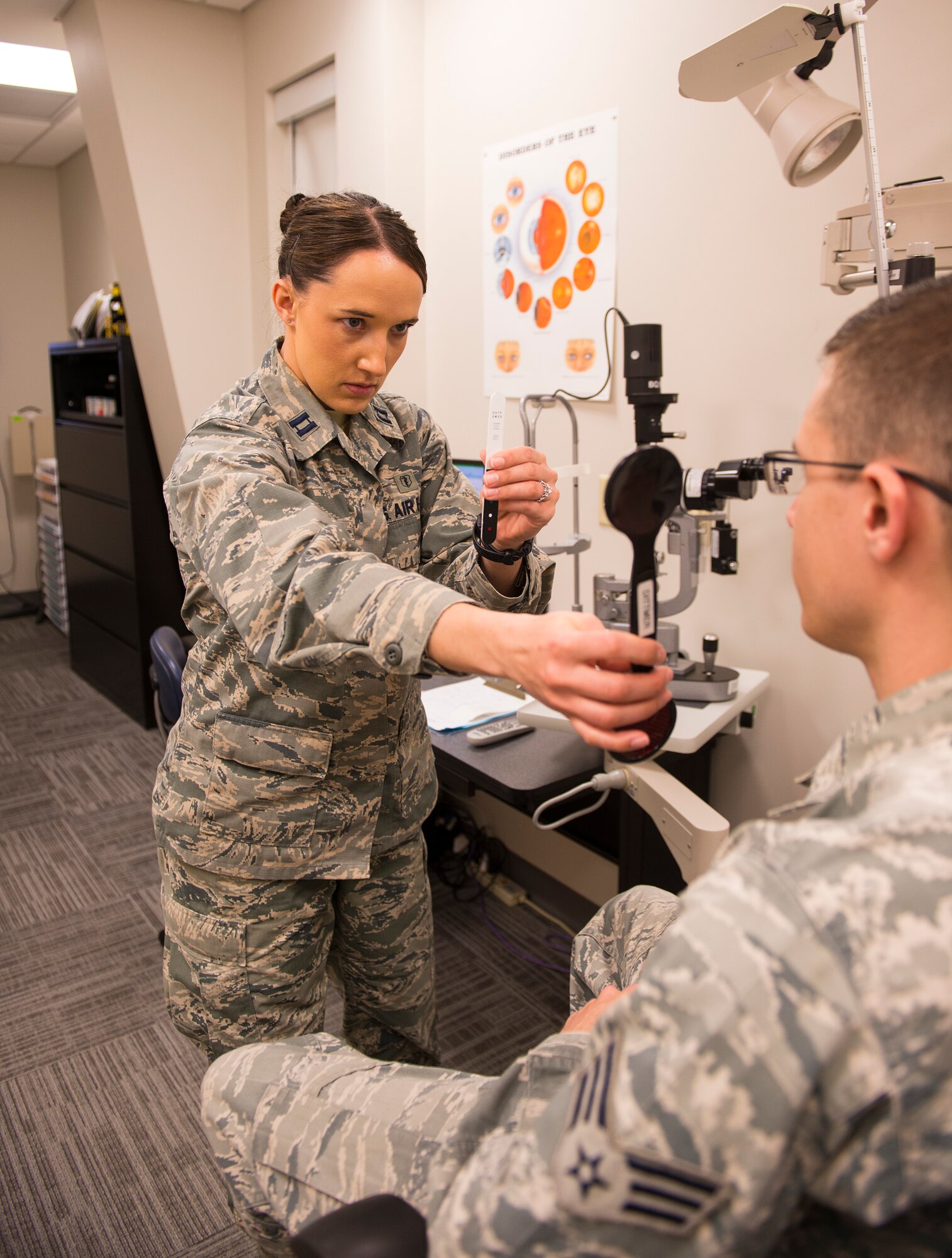 U.S. Air Force Capt. (Dr.) Kaylaen Dittmer, 23d Medical Group optometrist, performs a cover test on Senior Airman River Carson, 23d MDG public health technician, Feb. 4, 2014, at Moody Air Force Base, Ga. Dittmer used the test to check the alignment of Carson’s eyes. (U.S. Air Force photo by Airman 1st Class Ceaira Tinsley/Released)