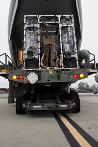 Airman 1st Class Jamal Cannon detaches tie downs on a Transport Isolation System aboard a C-17 Globemaster III, Jan. 14, 2015 at Joint Base Charleston, S.C., during a training exercise. Charleston is one of two bases in the United States that has trained with the TIS, a medical pod which provides a way to safely transport patients with infectious diseases. Cannon is member of the 69th Aerial Port Squadron at Joint Base Andrews, Md. (U.S. Air Force photo/Senior Airman Jared Trimarchi)  