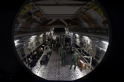 Aeromedical evacuation Airmen from throughout Air Mobility Command participated in an exercise of setting up a Transport Isolation System aboard a C-17 Globemaster III, Jan. 14, 2015 at Joint Base Charleston, S.C. Charleston was one of two bases in the United States training with the TIS, a medical pod which provides a way to safely transport patients with infectious diseases. (U.S. Air Force photo/Senior Airman Jared Trimarchi)  