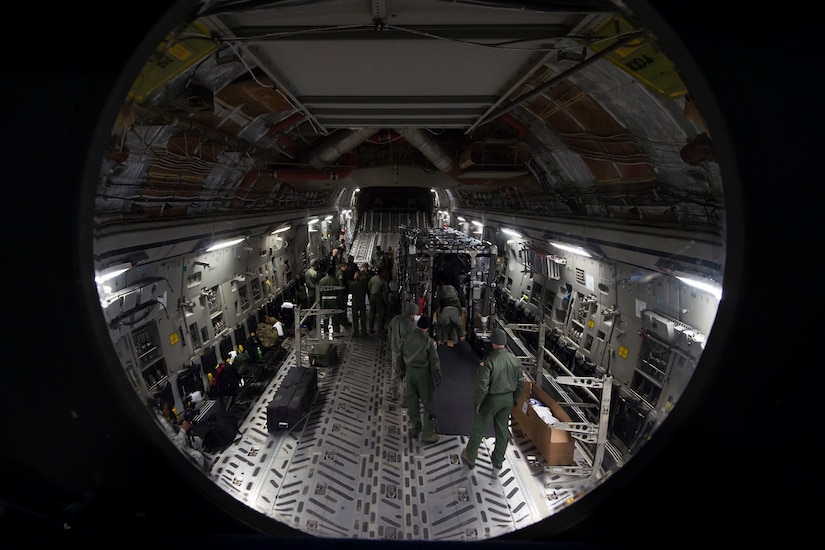 Aeromedical evacuation Airmen from throughout Air Mobility Command participated in an exercise of setting up a Transport Isolation System aboard a C-17 Globemaster III, Jan. 14, 2015 at Joint Base Charleston, S.C. Charleston was one of two bases in the United States training with the TIS, a medical pod which provides a way to safely transport patients with infectious diseases. (U.S. Air Force photo/Senior Airman Jared Trimarchi)  
