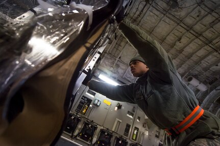 Airman 1st Class Jamal Cannon  aligns a Transport Isolation System aboard a C-17 Globemaster III, Jan. 14, 2015 at Joint Base Charleston, S.C., during a training exercise. Charleston is one of two bases in the United States  that has trained with the TIS, a medical pod which provides a way to safely transport patients with infectious diseases. Cannon is member of the 69th Aerial Port Squadron from Joint Base Andrews, Md. (U.S. Air Force photo/Senior Airman Jared Trimarchi)  