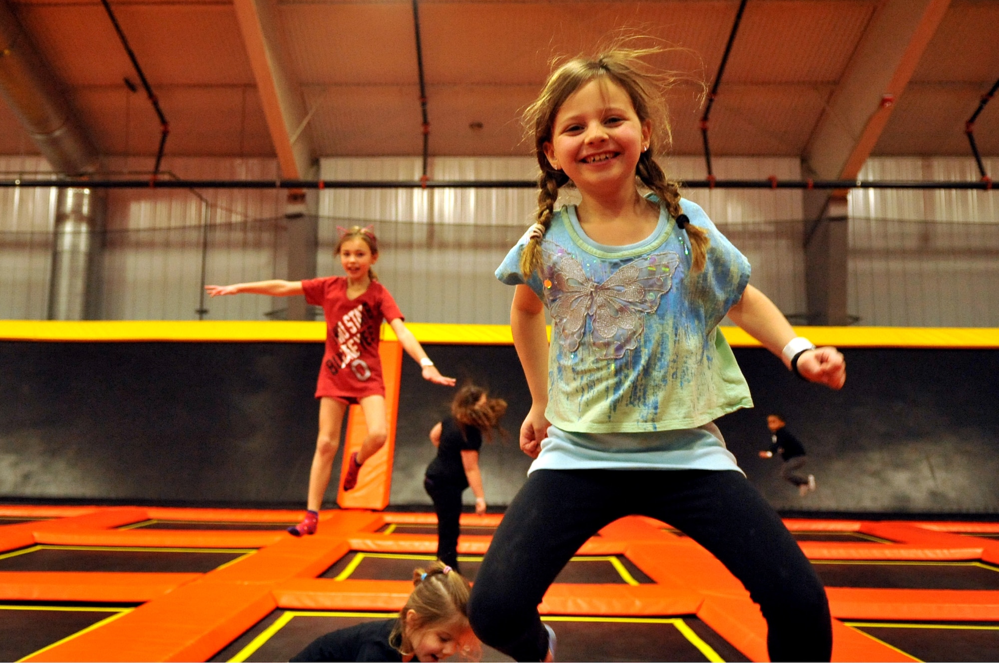 Leah Davis, 7, and more children from Grand Forks Air Force Base, N.D., jump on trampolines at Northern Air Family Fun Center in Grand Forks, Feb. 2, 2015. Service members and children from the base were invited to take part in a military appreciation night event featuring a trampoline park, laser tag, and free pizza and ice cream. (U.S. Air Force photo/Staff Sgt. Susan L. Davis)