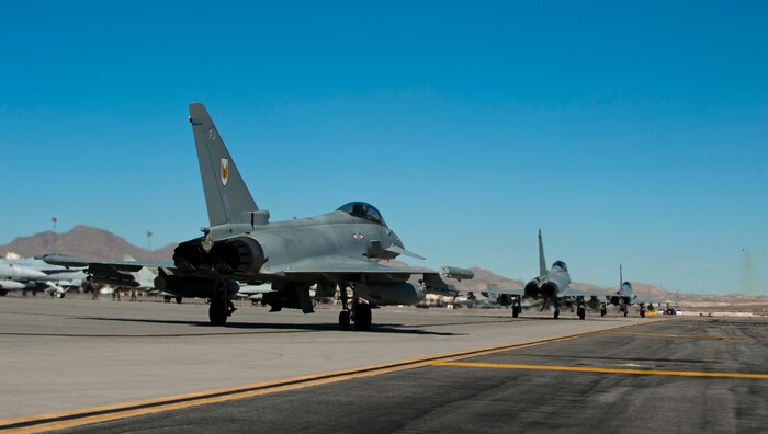 Royal Air Force Typhoon FGR4s, assigned to 1 (Fighter) Squadron, RAF Lossiemouth, Scotland, taxi to the runway for a training exercise during Red Flag 15-1 at Nellis Air Force Base, Nev., Feb. 2, 2015. Red Flag is a realistic combat exercise involving U.S. and allied air forces conducting training operations on the 12,000 square-nautical mile Nevada Test and Training Range. (U.S. Air Force photo by Senior Airman Thomas Spangler)