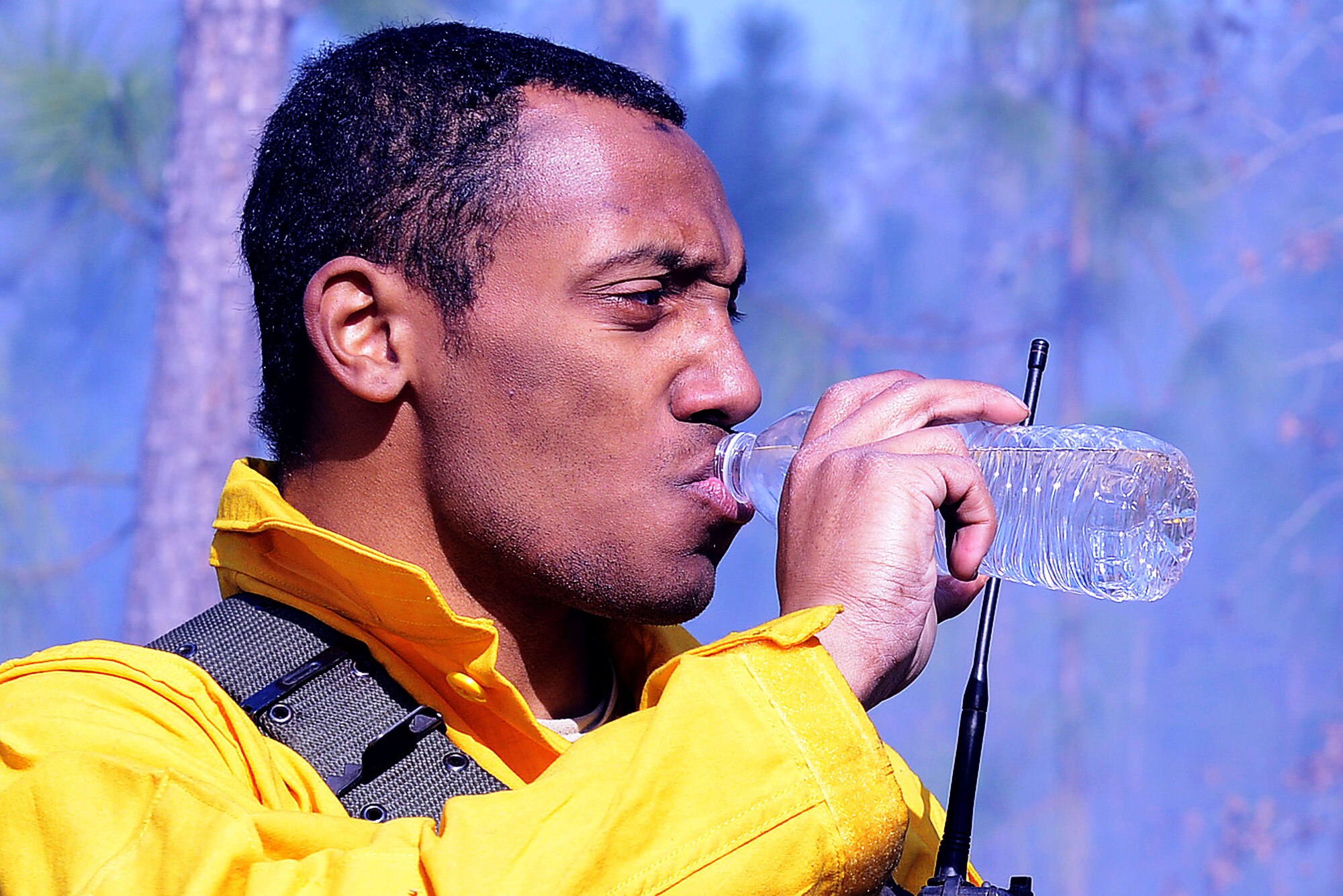 A member of the prescribe burn team takes a sip of water while monitoring the burning of forest floor fuels at Poinsett Electronic Combat Range, Sumter, S.C., Jan. 28, 2015. The fuels found at the forest floor consists of leaves, branches, or anything that has accumulated on the ground that can burn. It is important to remove the fuels on the bombing range to ensure an uncontrolled fire doesn’t occur. (U.S. Air Force photo by Airman 1st Class Diana M. Cossaboom/Released)