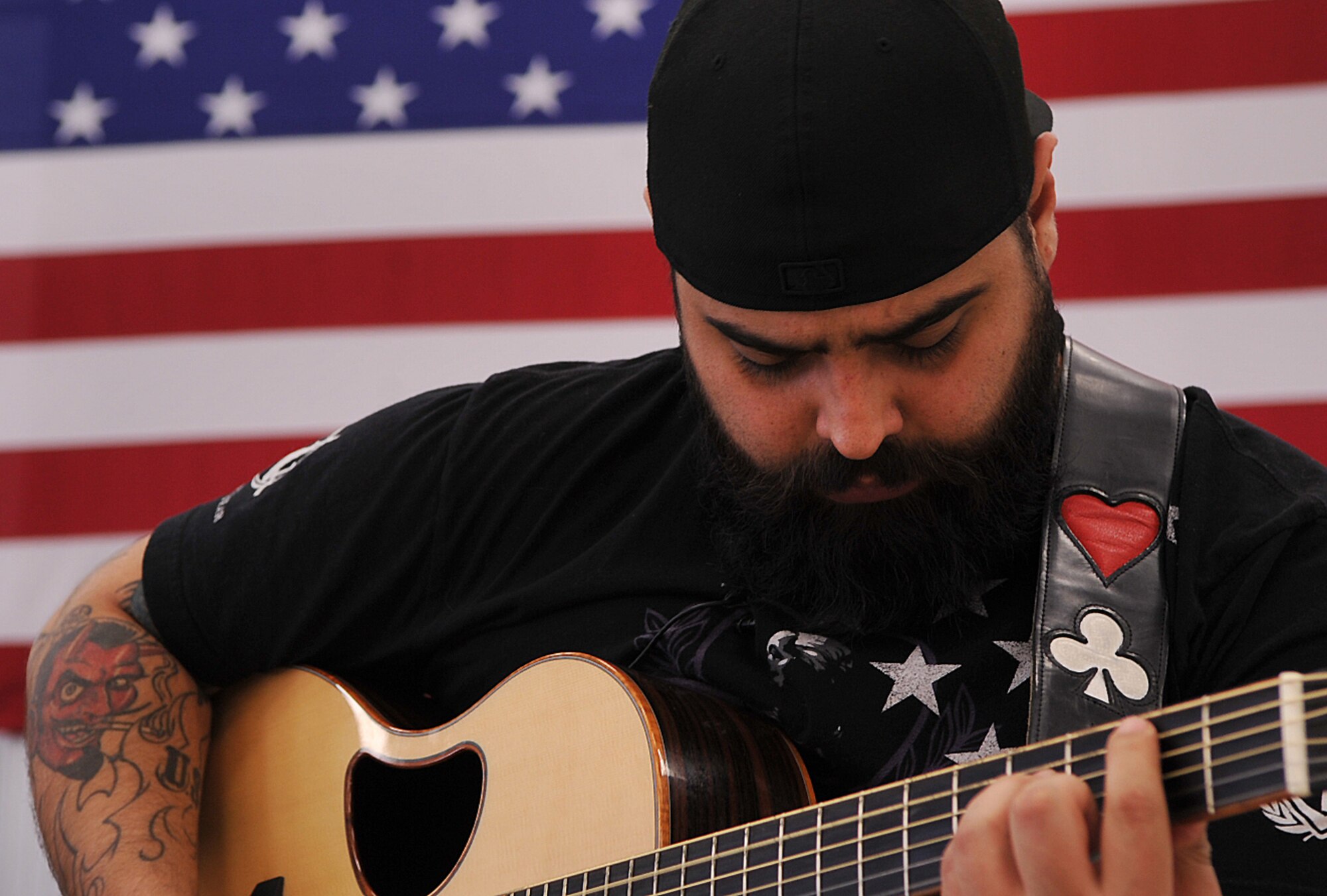 Wounded warrior Salvador Gonzalez, retired U.S. Marine Corps lance corporal, concludes his visit with 319th Air Base Wing Honor Guard Airmen with a song on Grand Forks Air Force Base, N.D. Jan. 29, 2015. Gonzalez became a wounded warrior when he lost his leg to an improvised explosive device while deployed in Ramadi, Iraq in 2004.  In 2014, Gonzalez appeared on America’s Got Talent. (U.S. Air Force photo/Airman 1st Class Bonnie Grantham)