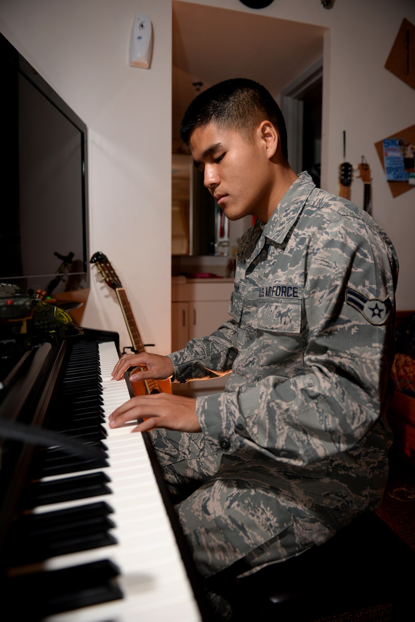 Airman 1st Class Linh Phan, 436th Supply Chain Operations Squadron, plays his electric piano in his dorm room at Scott Air Force Base, Illinois. Phan uses music to as method to his resilience and stability. He attends lessons every Saturday for an hour to improve his abilities with a piano. (U.S. Air Force photo/Senior Airman Jake Eckhardt)