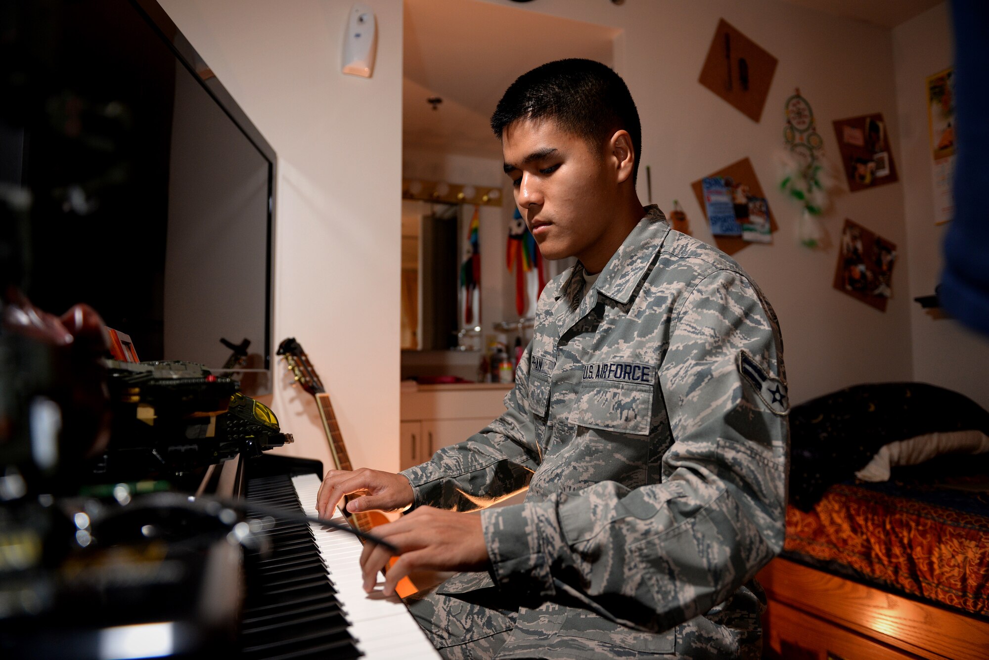 Airman 1st Class Linh Phan, 436th Supply Chain Operations Squadron, plays his electric piano in his dorm room at Scott Air Force Base, Illinois. Phan uses music to as method to his resilience and stability. He attends lessons every Saturday for an hour to improve his abilities with a piano. (U.S. Air Force photo/Senior Airman Jake Eckhardt)