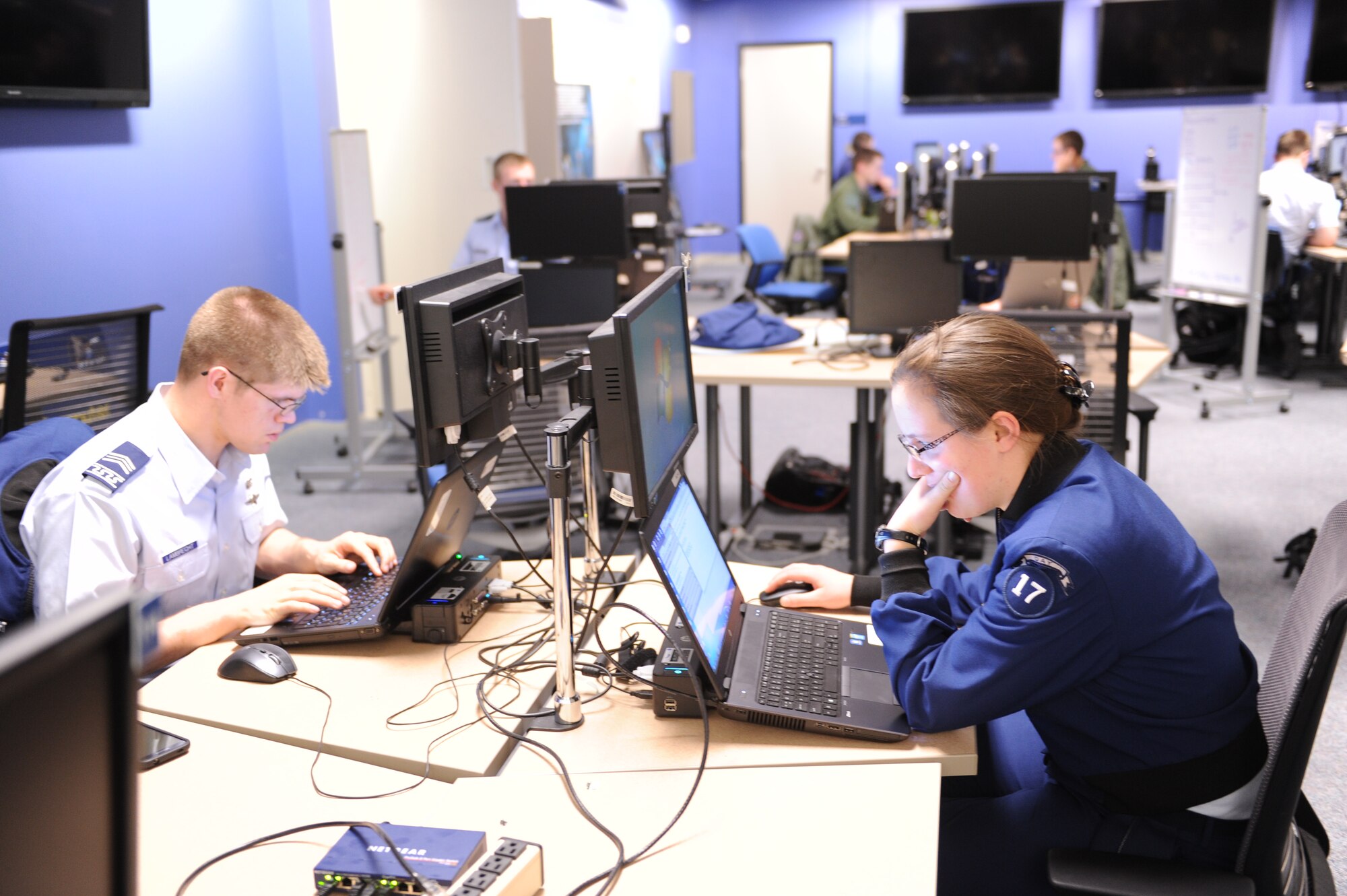Cadet 2nd Class Lucas Lambrecht, left, and Cadet 3rd Class
Rachel Eaton, right, each work on coding in the Air Force Academy's Cyber
Warfare Laboratory in preparation for an upcoming competition. Next up for
the cadets is the Rocky Mountain Collegiate Cyber Defense Competition, Feb.
27-28 at Regis University in the Denver Tech Center.