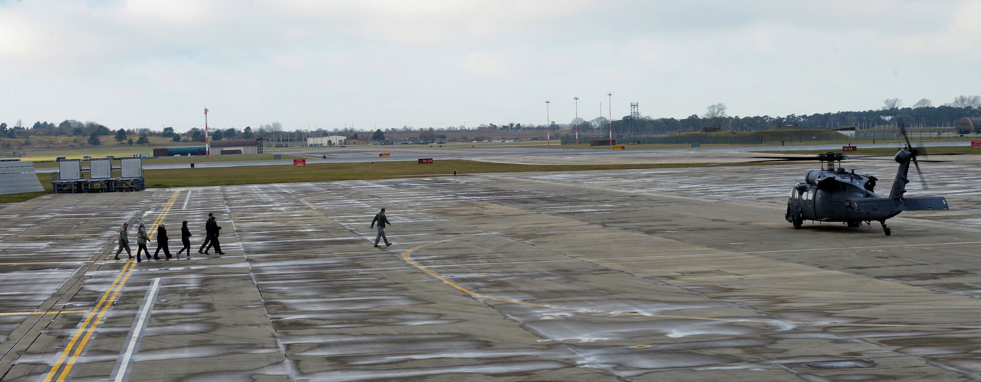 Liberty Wing leadership, 56th Rescue Squadron members and their spouses board an HH-60G Pave Hawk rescue helicopter for an incentive flight at Royal Air Force Lakenheath, England, Jan. 30, 2015. Brief, 15-minute flights were conducted by three helicopter crews to honor their spouse’s contributions to base operations and expose them to the rescue mission. (U.S. Air Force photo by Staff Sgt. Thomas Trower/Released)