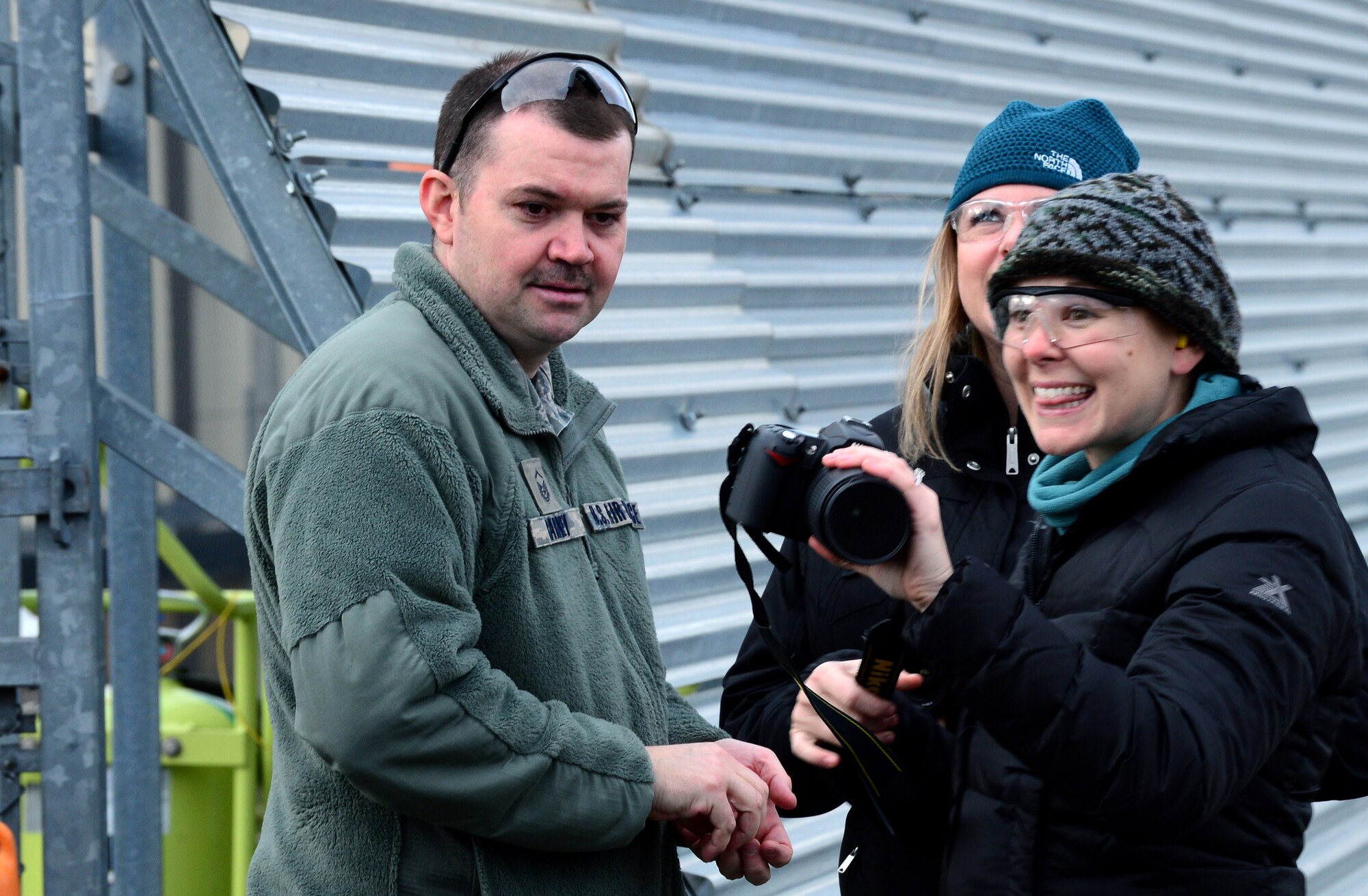 Spouses of Liberty Wing leadership and 56th Rescue Squadron members took photos on the flightline at Royal Air Force Lakenheath, England, before receiving incentive flights Jan. 30, 2015. Three HH-60G Pave Hawk rescue helicopter crews flew more than 130 members of wing leadership, the 56th RQS and their spouses to honor their contributions to base operations and expose them to the rescue mission. (U.S. Air Force photo by Staff Sgt. Thomas Trower/Released)