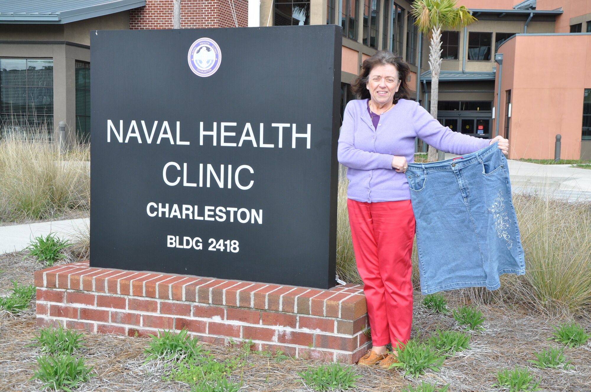 Teressa Armstrong shows off her slim figure next to a skirt she wore before losing 100 pounds under the guidance of Linda Washington, nutritionist for Naval Health Clinic Charleston, S.C. With the tools she learned from Washington, Armstrong has continued to keep the weight off for more than a year. (U.S. Navy photo / Petty Officer 3rd Class Caralyn Mulyk)

