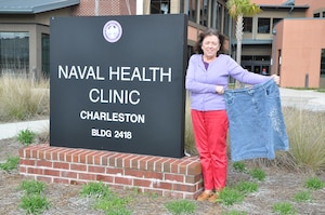 Teressa Armstrong shows off her slim figure next to a skirt she wore before losing 100 pounds under the guidance of Linda Washington, nutritionist for Naval Health Clinic Charleston, S.C. With the tools she learned from Washington, Armstrong has continued to keep the weight off for more than a year. (U.S. Navy photo / Petty Officer 3rd Class Caralyn Mulyk)
