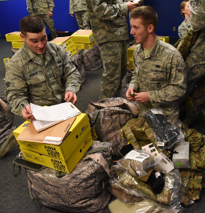 Senior Airman Jacob Monson, 341st Security Support Squadron supply custodian, helps an Airman with the issuing of Model Defender gear Feb. 2 at Malmstrom Air Force Base, Mont. Airmen were issued new items such as multi-cam uniforms, goggles, boots and cold weather gear. (U.S. Air Force photo/Airman 1st Class Joshua Smoot)
